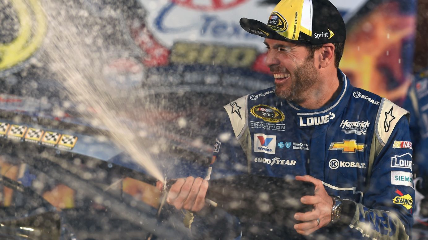 NASCAR driver Jimmie Johnson celebrates with champagne after he won the Sprint Cup race in Texas on Sunday, November 8. It was his 75th career victory in NASCAR's premier series.
