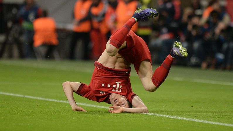 Bayern Munich striker Robert Lewandowski takes a tumble Wednesday, November 4, during a Champions League match in Munich, Germany.