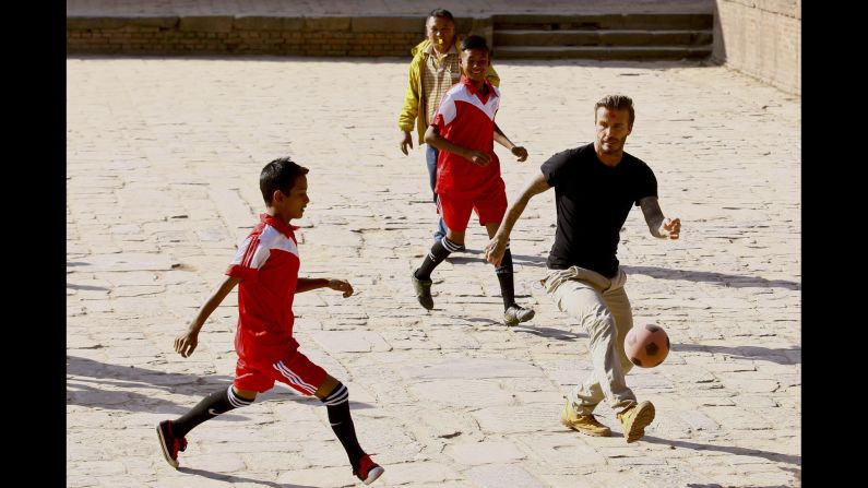 Former soccer star David Beckham plays a charity match with children in Bhaktapur, Nepal, on Friday, November 6. The match raised money for UNICEF.