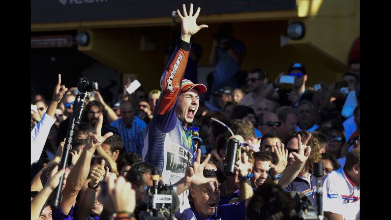 Motorcycle rider Jorge Lorenzo celebrates after his win in the Valencia Grand Prix clinched the MotoGP championship Sunday, November 8, in Cheste, Spain. This is the third time in Lorenzo's career that he has been MotoGP's world champion.