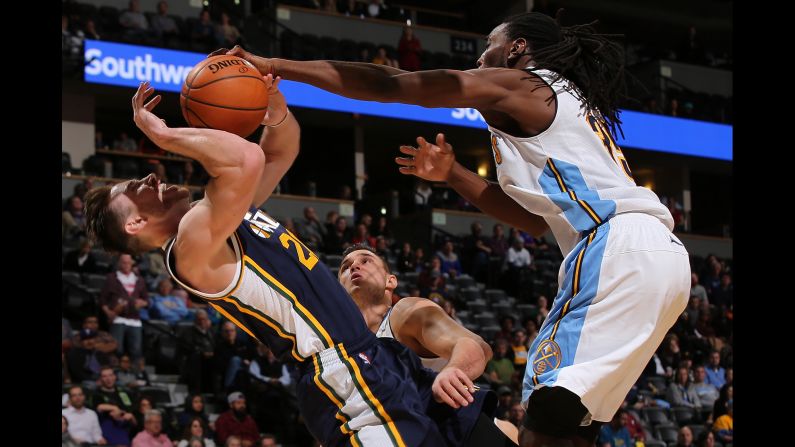 Utah's Gordon Hayward is fouled by Denver's Kenneth Faried during an NBA game in Denver on Thursday, November 5.