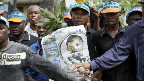 Supporters of executed activist Ken Saro-Wiwa carrying a poster of him during a march in Port Harcourt, Nigeria