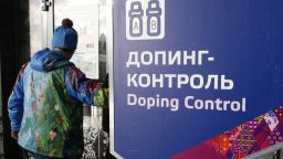 FILE - In this Feb. 21, 2014 file photo a man walks past a sign reading doping control, at the Laura biathlon and cross-country ski center, at the 2014 Winter Olympics in Krasnaya Polyana, Russia. In a devastatingly critical report, a World Anti-Doping Agency panel accused the Russian government on Monday of complicity in widespread doping and cover-ups by its track and field athletes and said they should all be banned from competition until the country cleans up its act. The report from a WADA commission that has been probing media allegations of widespread doping and deception in Russia said even the country's intelligence service, the FSB, was involved, spying on Moscow's anti-doping lab, including during last year's Winter Olympics in Sochi.  (AP Photo/Lee Jin-man, file)