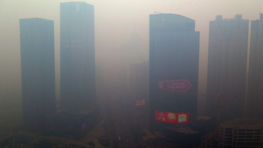 This picture taken on November 8, 2015 shows a residential block covered in smog in Shenyang, China's Liaoning province.  A swathe of China was blanketed with dangerous acrid smog after levels of the most dangerous particulates reached almost 50 times World Health Organization maximums.