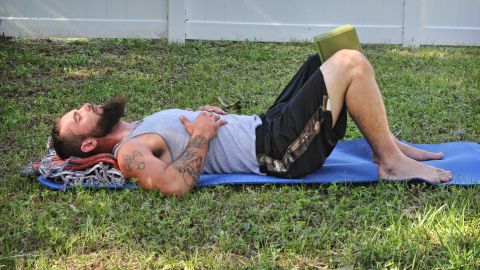 Lie on your back with your knees bent and feet flat, hip-distance apart, 6 to 8 inches from your bottom.