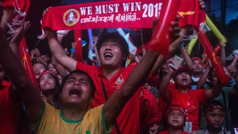 YANGON, MYANMAR - NOVEMBER 09: A man holds up a sign stating 'we must win' as crowds gather for the election result announcement in front of the National League for Democracy's headquarters after Myanmar's first free and fair election on November 9, 2015 in Yangon, Myanmar. The elections are Myanmar's first openly contested polls in 25 years, following decades of military rule. Noble laureate Aung San Suu Kyi appeared poised to win power in Myanmar on today despite her party's growing concerns about cheating in yesterday's historic election. (Photo by Lauren DeCicca/Getty Images)