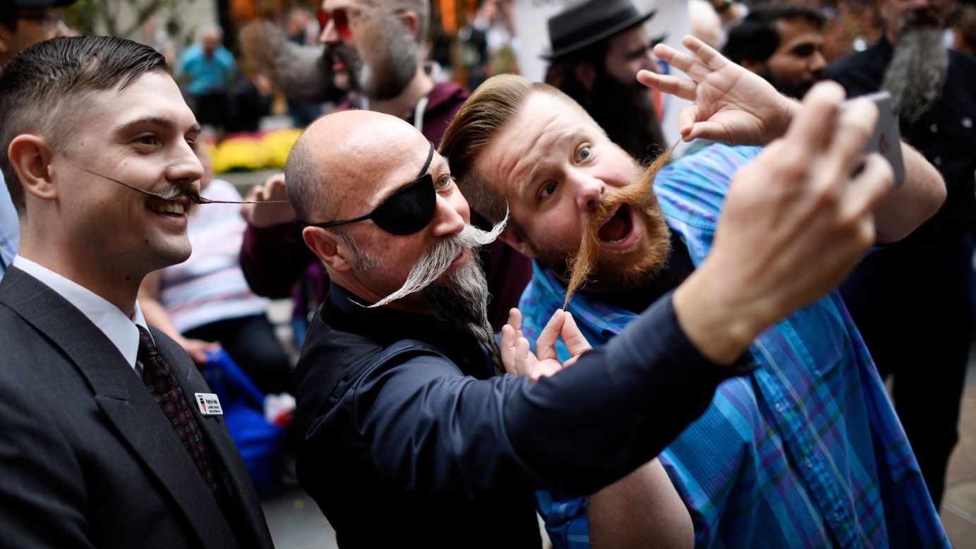 Mustachioed men take a photo together in New York on Friday, November 6. The city was hosting the National Beard and Moustache Championships.