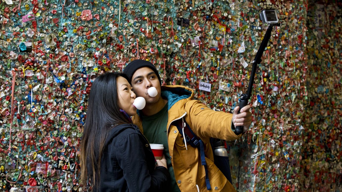 Two visitors take a selfie at the famous "gum wall" in Seattle on Monday, November 9. The wall, which had accumulated people's gum over 20 years, <a href="http://www.cnn.com/2015/11/04/travel/seattle-pike-place-gum-wall-cleaning-feat/" target="_blank">was scheduled for a deep cleaning.</a>