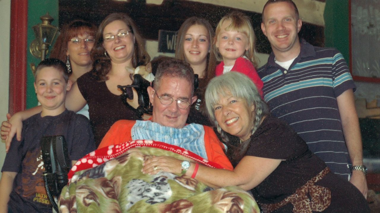 Carlo Russo is surrounded by his children and grandchildren.