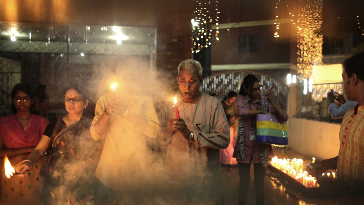 Men and women light candles at a temple in Dhaka, Bangladesh, on November 10. 