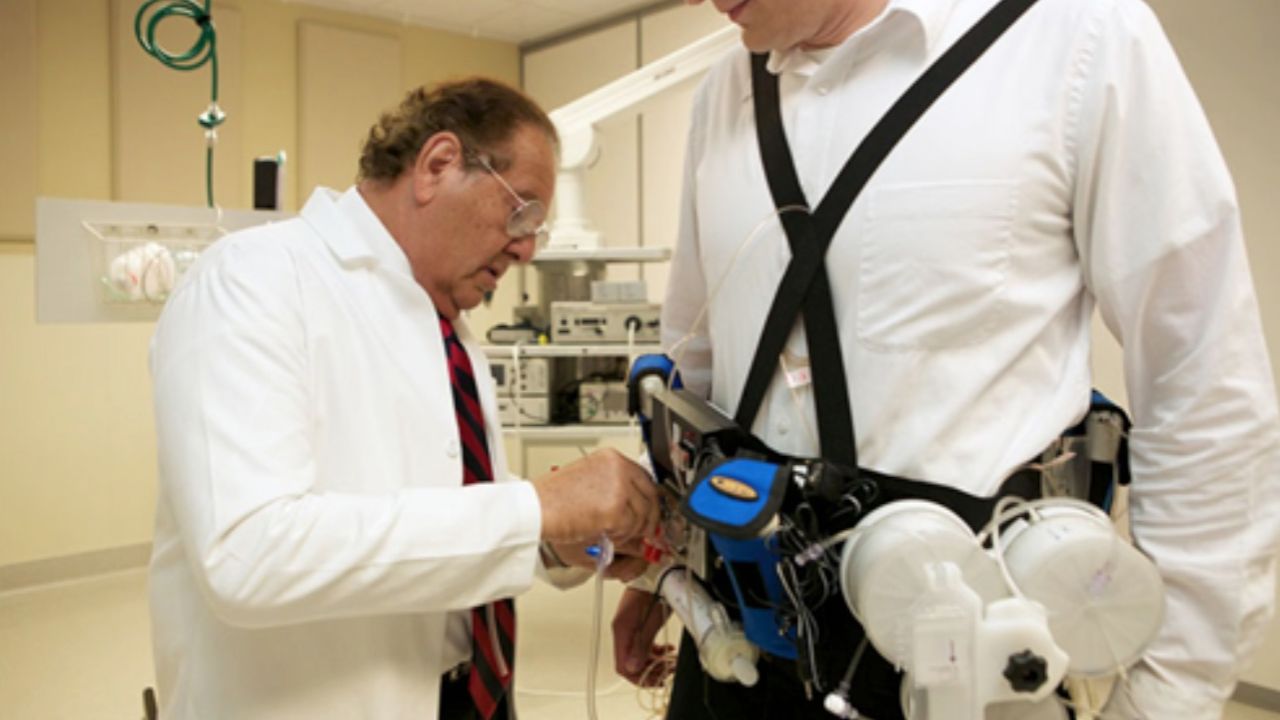 Victor Gura fits a "wearable artificial kidney," which filters a patient's blood continuously.