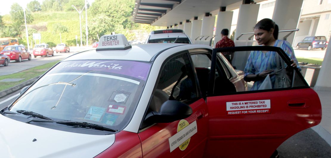 A woman takes a special female only taxi.