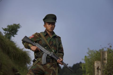 A fighter from the armed rebel movement known as the Ta'ang National Liberation Army, or TNLA, stands in the mountains of north-eastern Myanmar. 