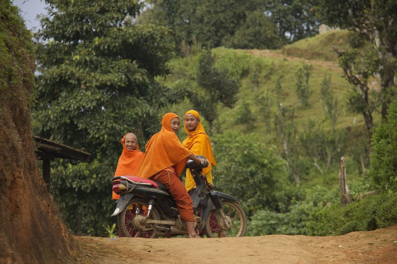Local men on motorbikes. The TNLA claims to defend the interests of Myanmar's Ta'an ethnic minority, which they say has a population of one million. 