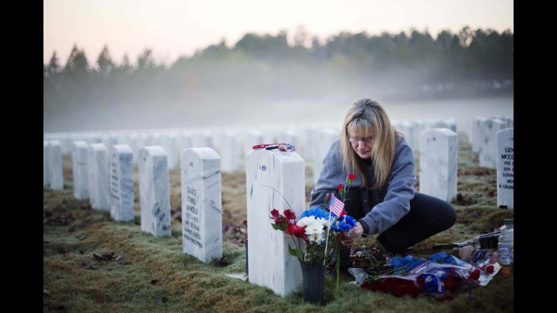Jiffy Helton Sarver places flowers at the grave of her son, Air Force 1st Lt. Joseph Helton Jr., at the Georgia National Cemetery in Canton, Georgia. He was killed while serving in Iraq in 2009. "This was his favorite time of day," his mother said. "He loved sunrises."
