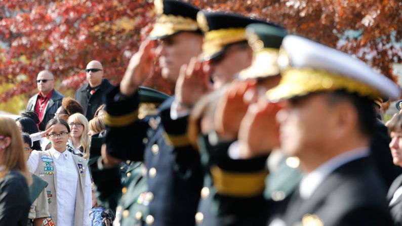 A Girl Scout salutes with U.S. and South Korean troops during a Veterans Day ceremony in Seoul, South Korea.