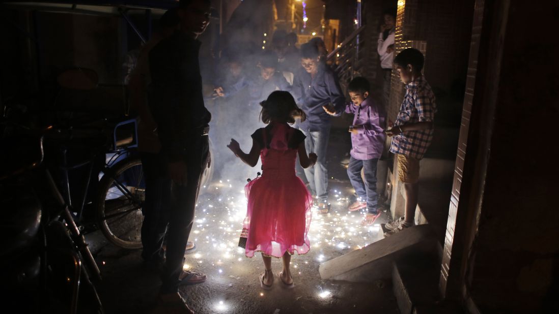 Children play with firecrackers during festivities in New Delhi on November 11.