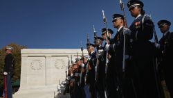 Members of a Marine and Air Force honor guard stand next to The Tomb of the Unknowns during a wreath laying ceremony on Veterans Day at Arlington National Cemetery November 11, 2014 in Arlington, Virginia.