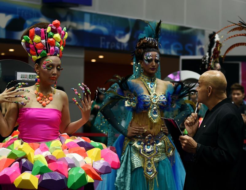 Gan says Malaysians are becoming more concerned with design. Here a judge looks at models as they present creations by stylists during a hairstyling and make-up competition in Kuala Lumpur.  