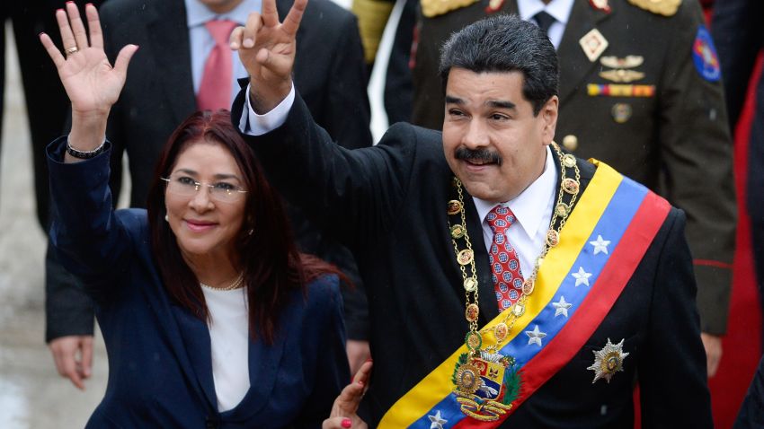 Venezuelan President Nicolas Maduro (R) and his wife Cilia Flores (L) wave upon their arrival at the National Assembly for a session commemorating Independence Day in Caracas on July 5, 2015. AFP PHOTO/FEDERICO PARRA        (Photo credit should read FEDERICO PARRA/AFP/Getty Images)