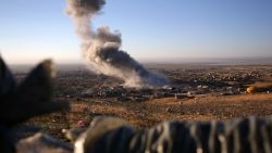 Smoke believed to be from an airstrike billows over the northern Iraqi town of Sinjar on Thursday, Nov. 12, 2015. Kurdish Iraqi fighters, backed by the U.S.-led air campaign, launched an assault Thursday aiming to retake the strategic town of Sinjar, which the Islamic State overran last year in an onslaught that caused the flight of tens of thousands of Yazidis and first prompted the U.S. to launch airstrikes against the militants. (AP Photo/Bram Janssen)