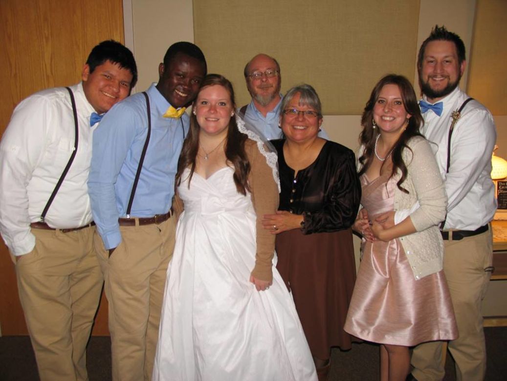 Kristin and Eric Njimegni pose with her family during their wedding reception in Grand Rapids, Minnesota, on December 2013.