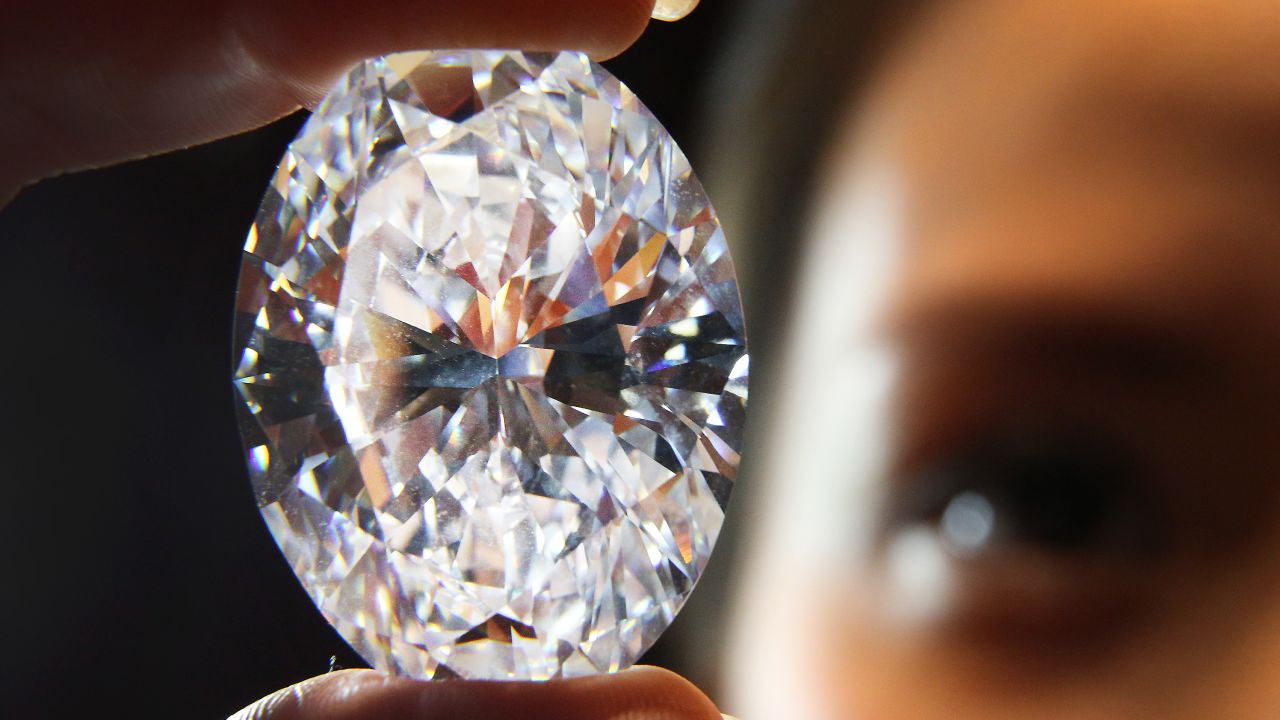 A Sotheby's employee holds huge white oval diamond that was auctioned in 2013. Scientists have created a substance that can now outmatch a diamond in hardness and brilliance.