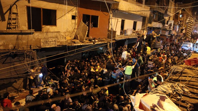 Emergency personnel and civilians gather at the site of a <a href="index.php?page=&url=http%3A%2F%2Fwww.cnn.com%2F2015%2F11%2F12%2Fmiddleeast%2Fbeirut-explosions%2Findex.html" target="_blank">twin suicide bombing</a> in the southern suburbs of the capital Beirut on Thursday, November 12. The two bombings killed at least 41 people and wounded over 200 more Thursday evening in southern Beirut, Lebanese Health Minister Wael Abu Faour said.