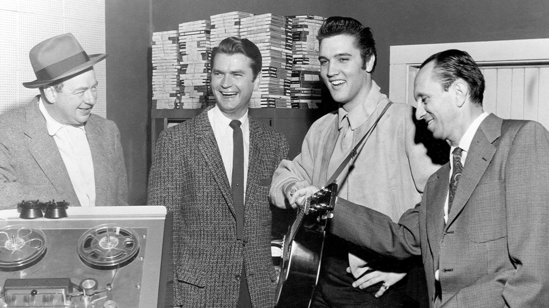 Phillips' most important find was Elvis Presley, who first wandered into the studio in 1953. The next year, Phillips started producing his sides, and such songs as "That's All Right," "Baby Let's Play House" and "Trying to Get to You" made him a star. Phillips sold Presley's contract to RCA in late 1955 for $35,000 -- considered an outrageous sum. The rest, however, is history. He poses here with reporter Leo Soroka, Phillips and reporter Robert Johnson in 1956. 