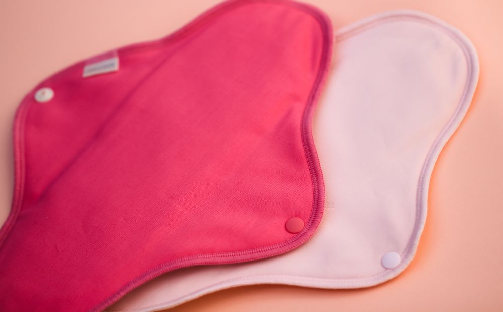 Reusable cloth pads are typically held in place by a snap and can be washed between uses.