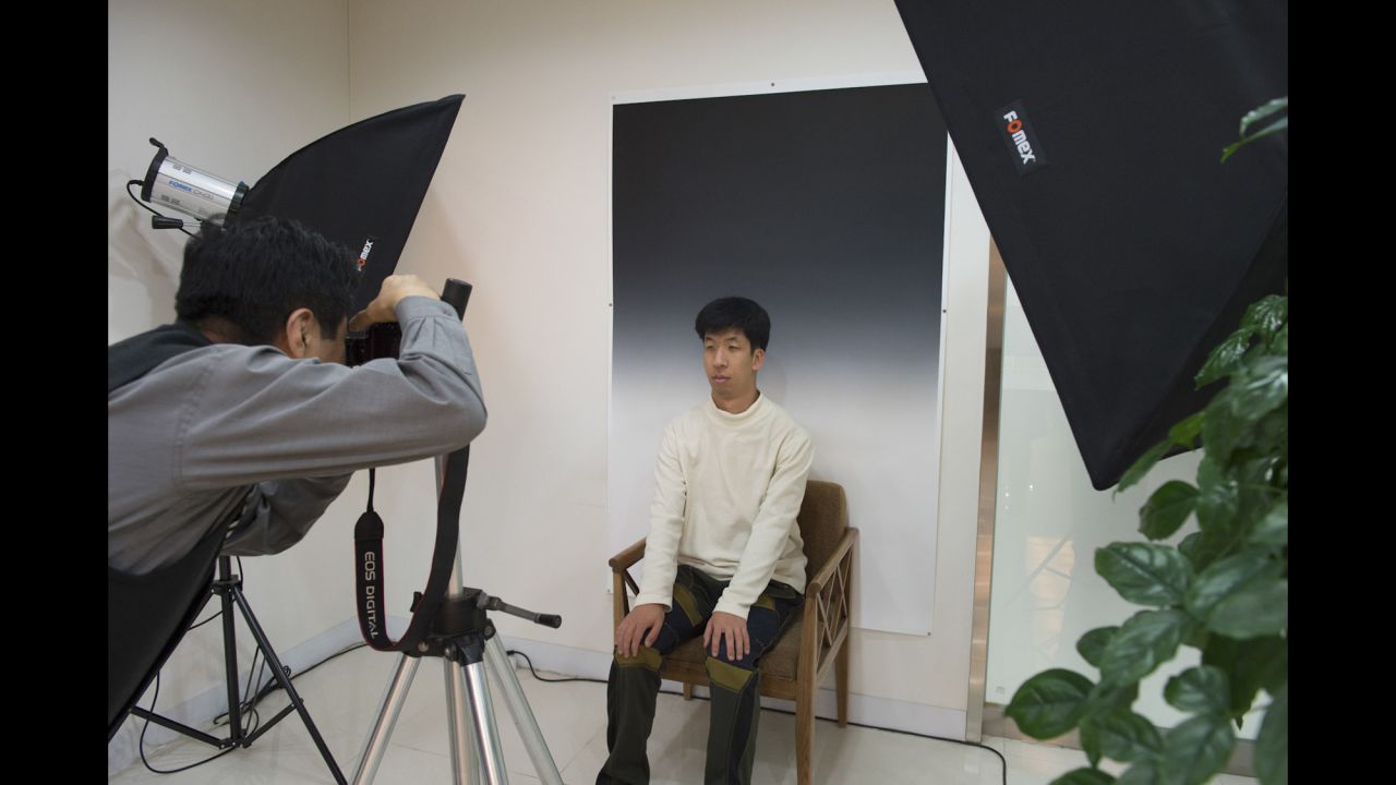 A boy has his photo taken at the Hyowon Healing Center. After participants arrive, their portraits are taken in the same style as photos found on the coffins of dead people, Huguier said.