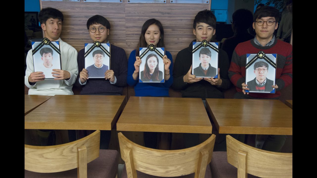 Participants pose with their funeral portraits.