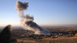 Smoke believed to be from an airstrike billows over the northern Iraqi town of Sinjar on Thursday, Nov. 12, 2015. Kurdish Iraqi fighters, backed by the U.S.-led air campaign, launched an assault Thursday aiming to retake the strategic town of Sinjar, which the Islamic State overran last year in an onslaught that caused the flight of tens of thousands of Yazidis and first prompted the U.S. to launch airstrikes against the militants. (AP Photo/Bram Janssen)