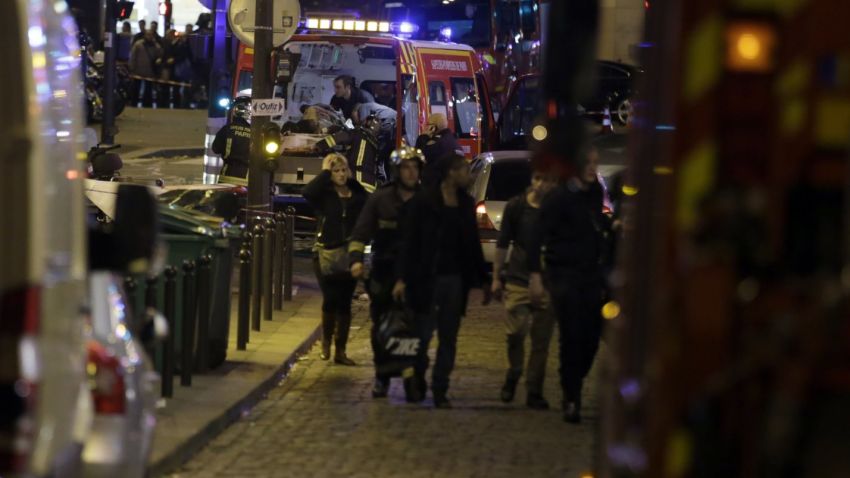Security moves people along Rue Bichat following a string of attacks in the French capital Paris on November 13, 2015. At least 18 people were killed as multiple shootings and explosions hit Paris Friday, police said. Police also said there was an ongoing hostage crisis in the Bataclan a concert hall in the French capital. AFP PHOTO / KENZO TRIBOUILLARDKENZO TRIBOUILLARD/AFP/Getty Images