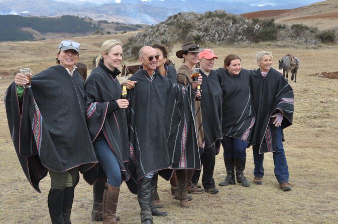 Poncho-wearing riders pose for a photo during a trip to Peru.  