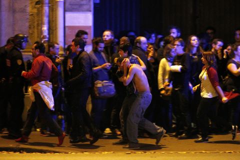 Wounded people are evacuated outside the scene of a hostage situation at the Bataclan theater in Paris on November 13.
