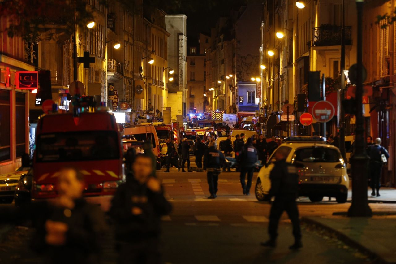 Police, firefighters and rescue workers secure the area near the Bataclan concert hall on November 14.