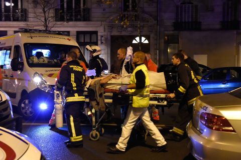 Rescuers evacuate an injured person on Boulevard des Filles du Calvaire, close to the Bataclan concert hall in central Paris.