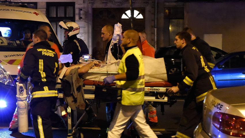Rescuers evacuate an injured person on Boulevard des Filles du Calvaire, close to the Bataclan concert hall in central Paris.