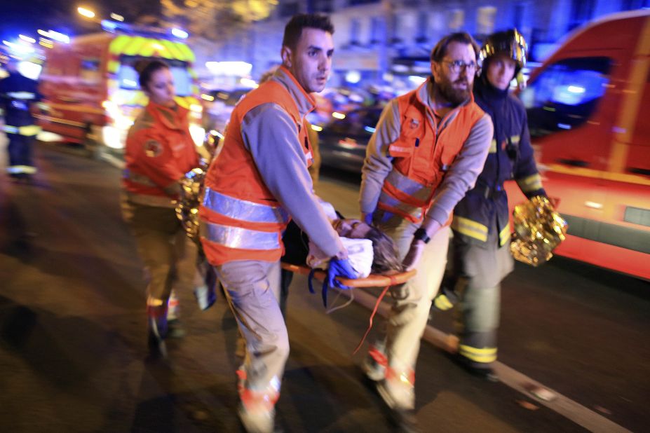 A woman is evacuated from the Bataclan theater early on November 14.