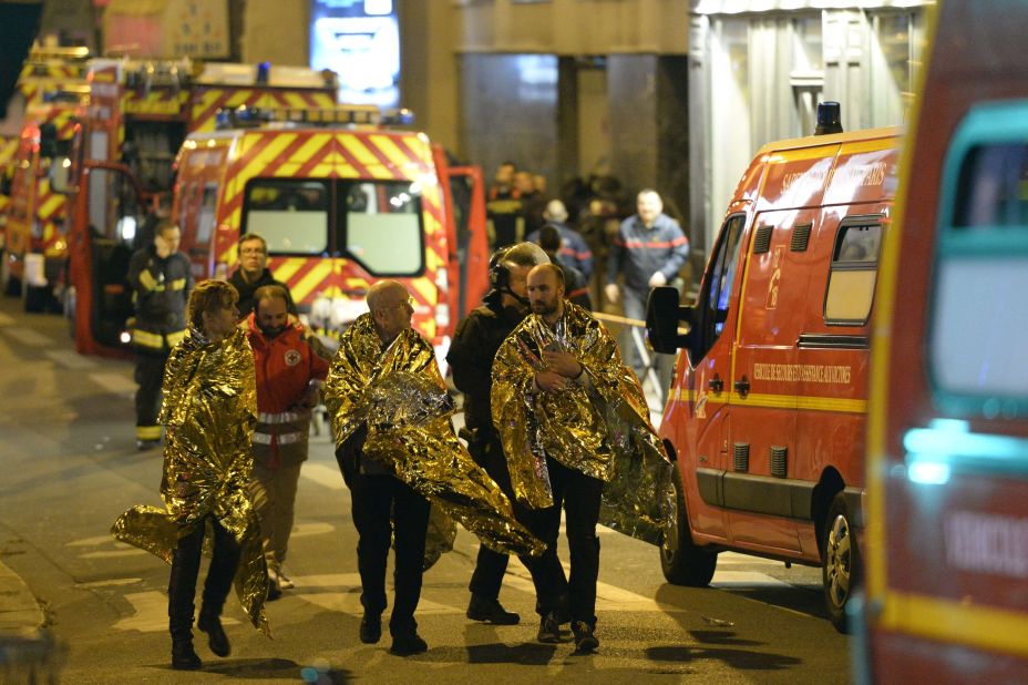 Security forces evacuate people on Rue Oberkampf near the Bataclan concert hall early on November 14.