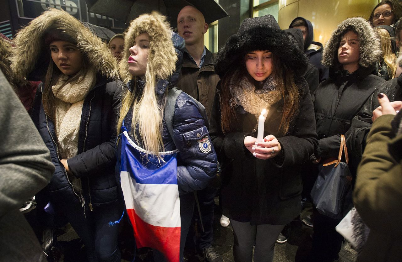 People attend a vigil outside the French Consulate in Montreal. Prime Minister Justin Trudeau offered "all of Canada's support" to France on Friday, November 13, in the wake of the attacks.