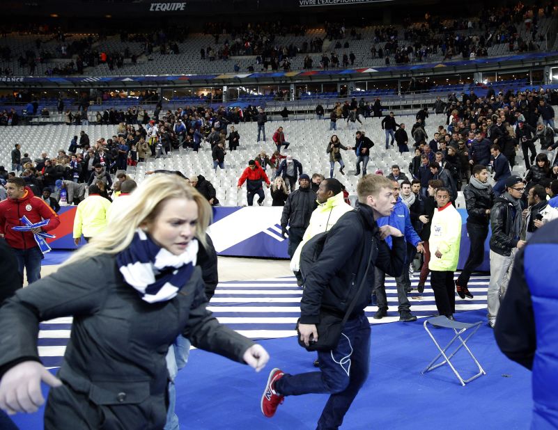 Spectators invade the pitch of the Stade de France stadium after the international friendly soccer match between France and Germany in Saint-Denis.