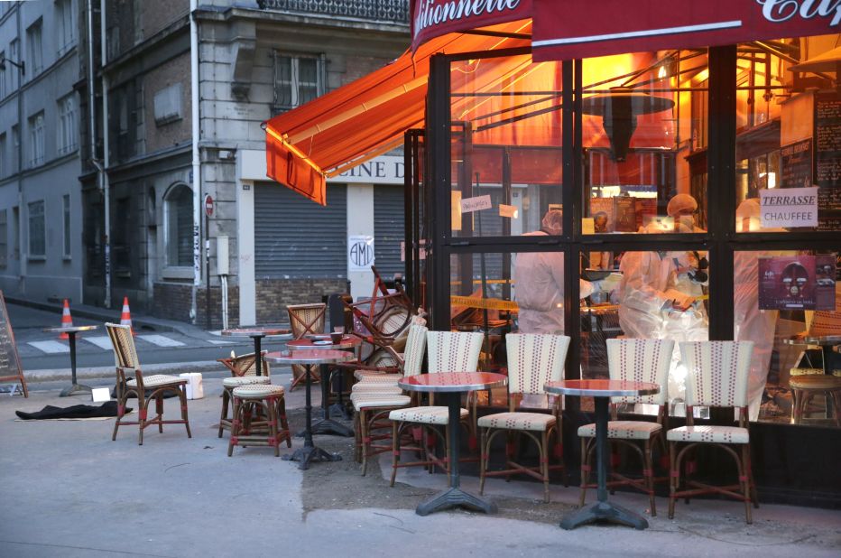 Forensic police search for evidence inside the Comptoir Voltaire cafe after the attacks.