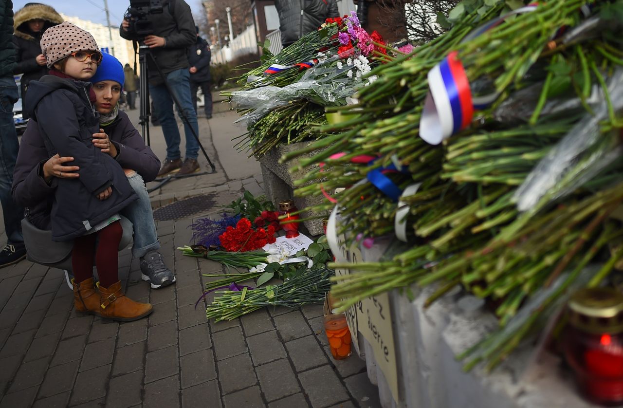 People lay flowers outside the French Embassy in Moscow on November 14.