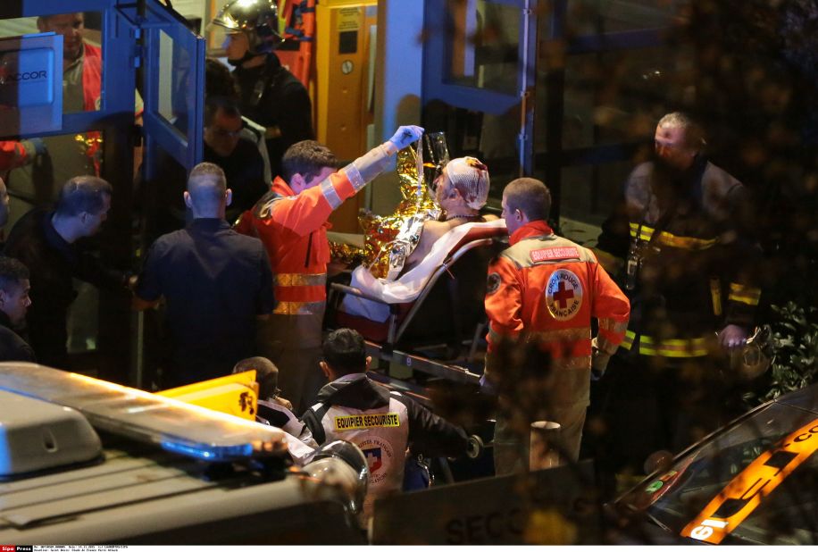 Rescuers evacuate an injured person near the Stade de France, one of several sites of attacks November 13 in Paris. Thousands of fans were watching a soccer match between France and Germany when the attacks occurred.
