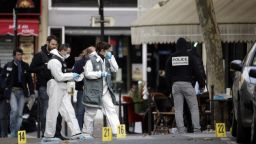 Forensic scientists inspect the Cafe Bonne Biere on Rue du Faubourg du Temple in Paris on Saturday, November 14 following a series of coordinated attacks in and around Paris late Friday.