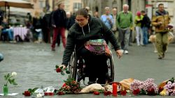 A woman brings flowers outside the French Embassy in Rome on November 14, a day after deadly attacks in Paris.