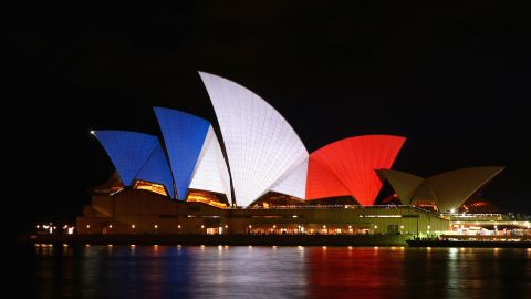 The Sydney Opera House is illuminated in the colors of the French flag.