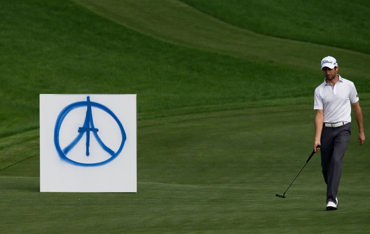 French golfer Gregory Bourdy passes a peace symbol for the Paris victims during the BMW Shanghai Masters tournament November 15 in Shanghai, China. 